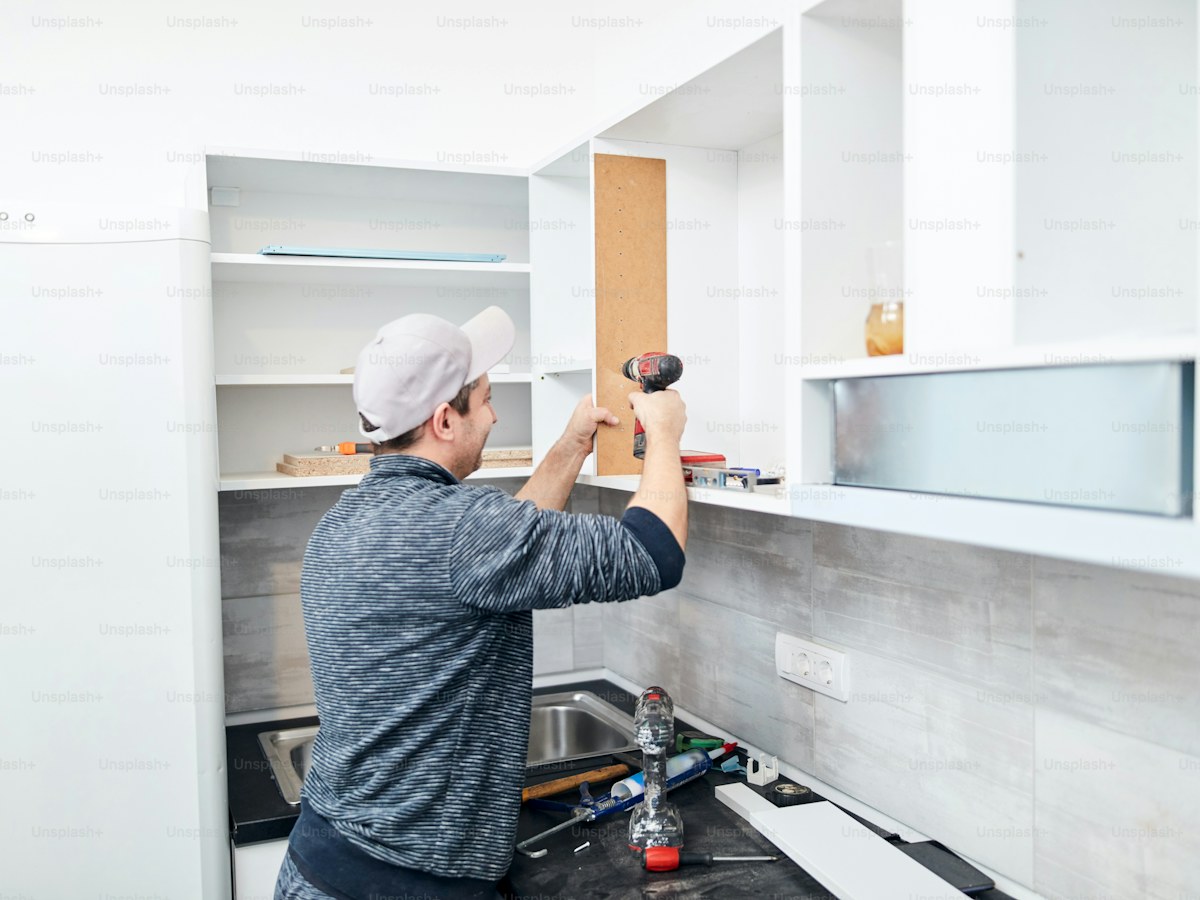 Handyman worker assembling furniture and fixing it