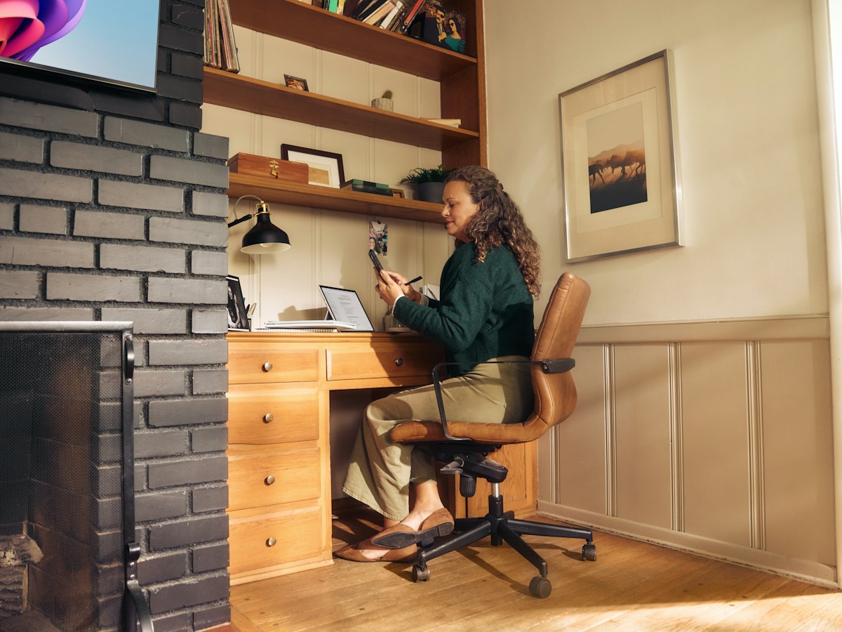 Woman working at a desk in a cozy home office