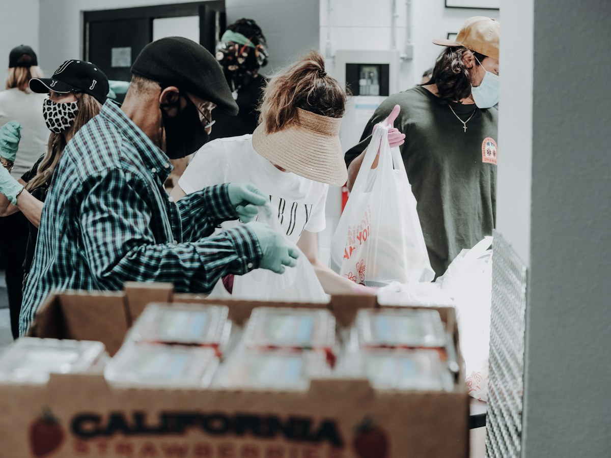 people standing in front of brown cardboard boxes